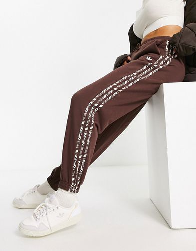 Pantalon de jogging à trois bandes à imprimé animal abstrait - Adidas Originals - Modalova