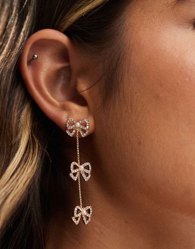 Boucles d'oreilles pendantes avec petit naud et chaîne - Asos Design - Modalova