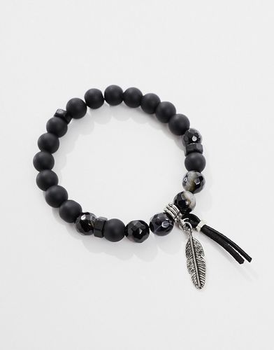Bracelet de perles avec breloque plume et pierres volcaniques - Noir - Asos Design - Modalova