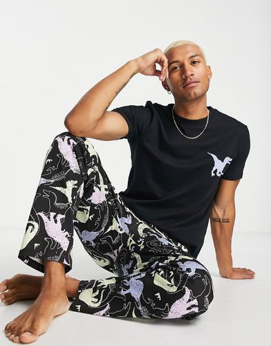 Ensemble de pyjama confort avec pantalon et t-shirt à imprimé dinosaure - Asos Design - Modalova