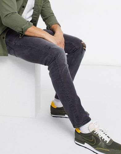 Jean slim stretch effet usé avec déchirures aux genoux - délavé - Asos Design - Modalova