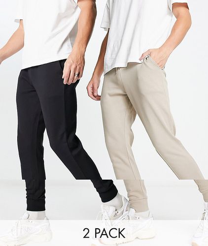 Lot de 2 pantalons de jogging skinny - Beige/noir - Asos Design - Modalova