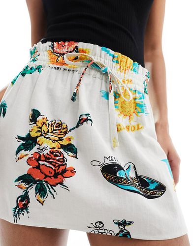 Mini-jupe nouée à la taille en aspect lin imprimé tropical - Asos Design - Modalova