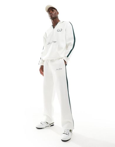 Pantalon de jogging ample avec bande latérale et imprimé - Beige - Asos Design - Modalova