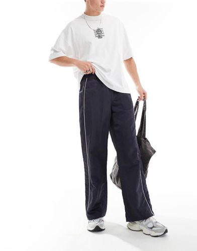 Pantalon de survêtement baggy en nylon avec passepoil contrastant - Asos Design - Modalova