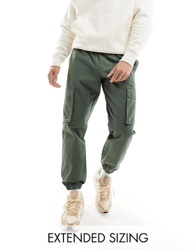 Pantalon fuselé à taille élastique facile à enfiler - Kaki - Asos Design - Modalova