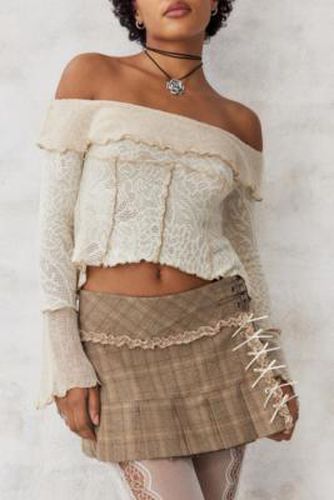 UO - Mini-jupe plissée kitsch à carreaux et nauds par en taille: XS - Urban Outfitters - Modalova